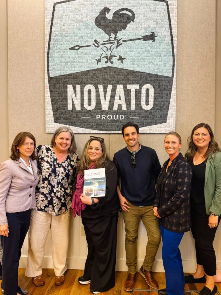 Six members of the ADFN team holding the Community Action Plan